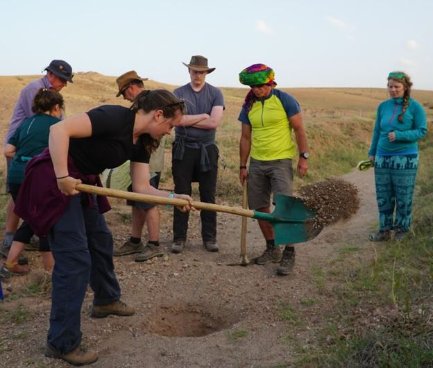 a woman digging with a shovel
